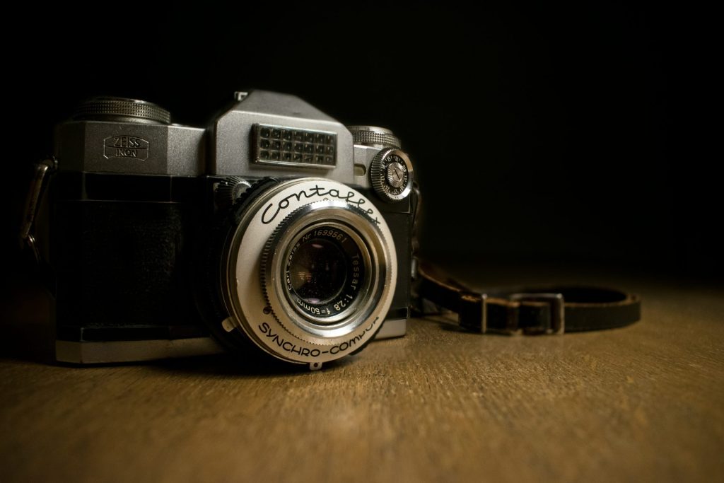 closeup photography of gray and black camera on table